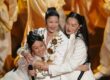 KPop Demon Hunters singers REI AMI, EJAE, and Audrey Nuna embrace after Oscars "Golden" performance.