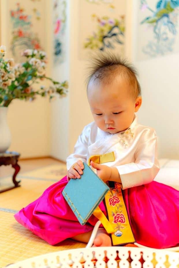 Korean baby playing with a gift