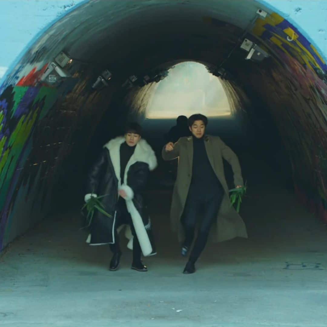 Two men running through Sinchon Graffiti Tunnel Seoul