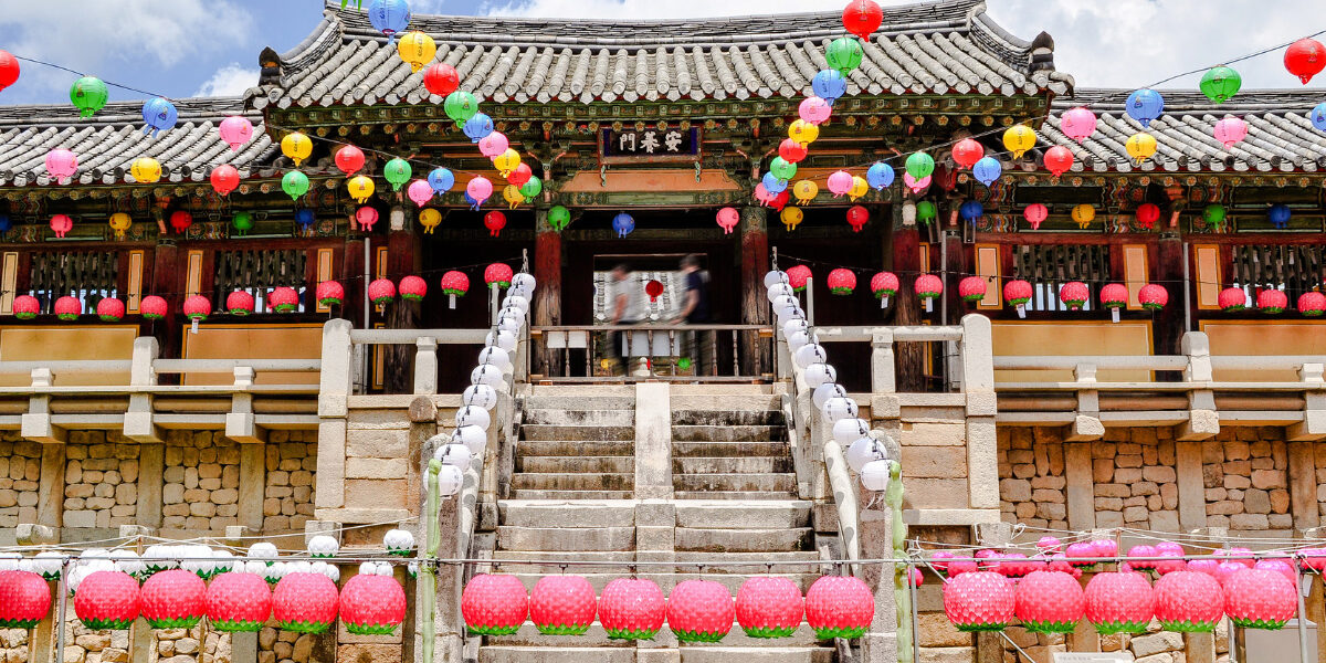 bok_buddhas-birthday_hero The front of entrance of a Korean Buddhist temple with colorful lanterns hanging above to honor Buddha’s birthday.