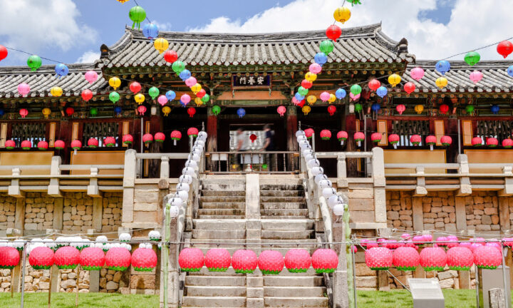 bok_buddhas-birthday_hero The front of entrance of a Korean Buddhist temple with colorful lanterns hanging above to honor Buddha’s birthday.