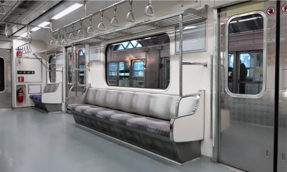 The inside of a Seoul subway cart with no people. The interior is shades of gray, white, and silver.