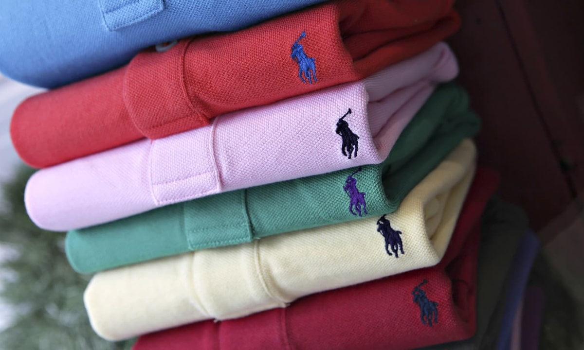 Stacks of colorful Ralph Lauren polo shirts with embroidered logos, neatly folded.