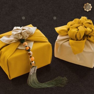 Beautifully wrapped gifts in traditional Korean cloth, featuring bold colors and tassel accents.