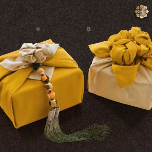 Beautifully wrapped gifts in traditional Korean cloth, featuring bold colors and tassel accents.