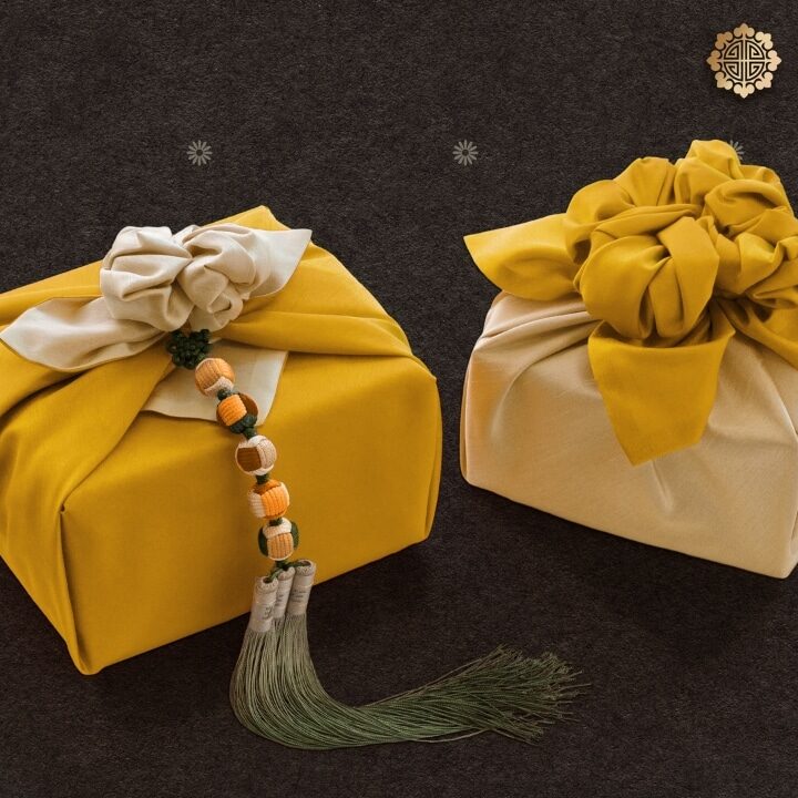 Beautifully wrapped gifts in traditional Korean cloth, featuring bold colors and tassel accents.