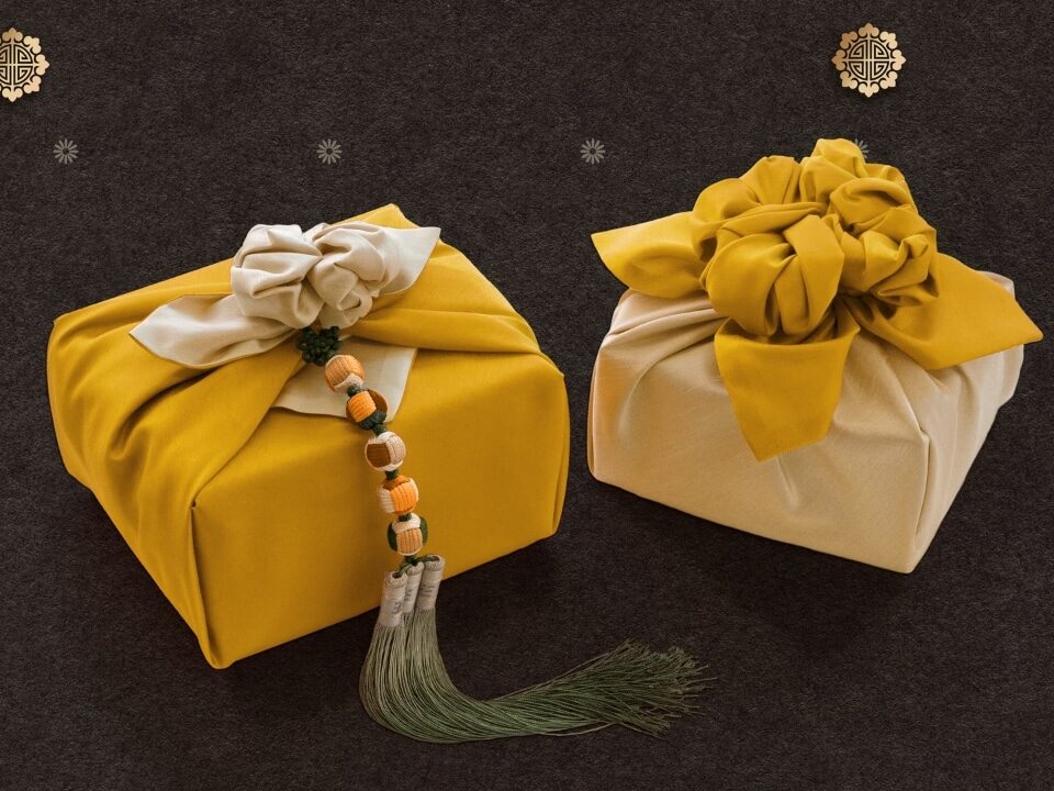Beautifully wrapped gifts in traditional Korean cloth, featuring bold colors and tassel accents.