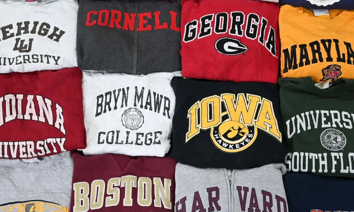 A collection of American university sweatshirts, including Cornell, Georgia, and Harvard, folded in vibrant colors.